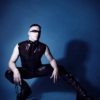 Men's sleeveless latex top shown in translucent black with black side panels.